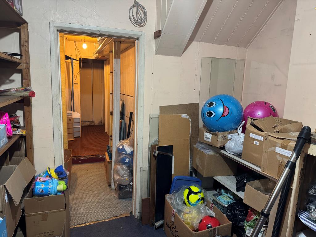 Lot: 94 - DOUBLE-FRONTED HIGH STREET SHOP WITH LARGE REAR STORES WITH POTENTIAL AND FREEHOLD INTEREST IN TWO FLATS OVER - View to the rear of the Shop
